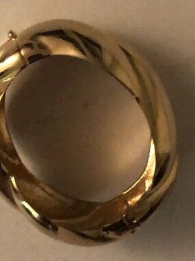 One golden heavy bracelet with a hinge opening, unbranded